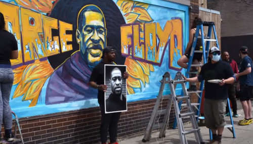 Artists painting a mural of George Floyd
