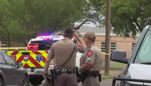 Police stand outside Uvalde elementary school in aftermath