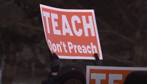 Protestors voicing their concerns about political propaganda in schools
